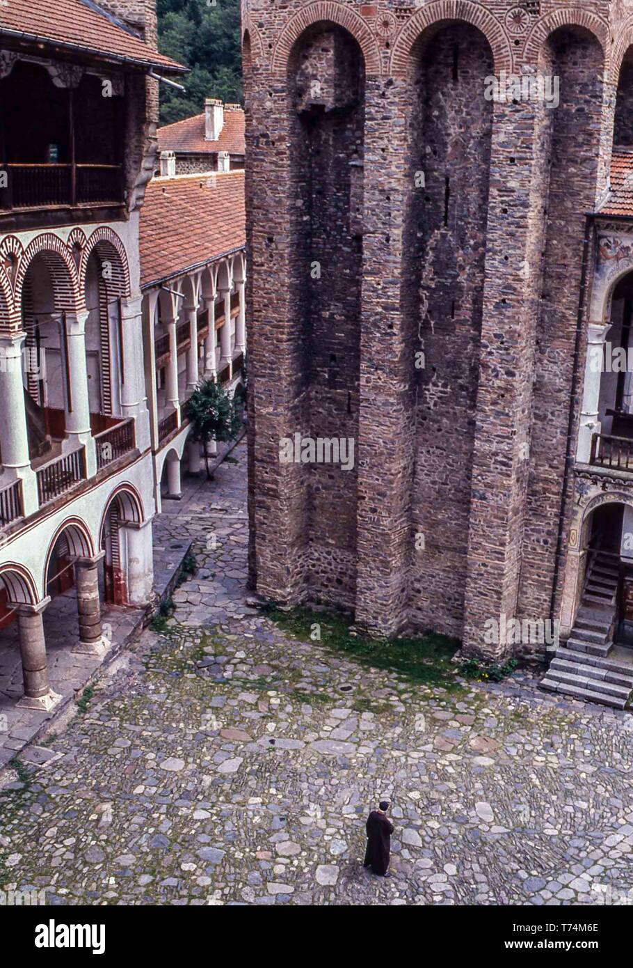 Kyustendil, Bulgaria. 1st Aug, 1991. A monk, with head bowed, walks in the courtyard of the 10th century Rila Monastery (Monastery of Saint Ivan of Rila), the largest and most famous Bulgarian Eastern Orthodox monastery, in the southwestern Rila Mountains, is inside of Rila Monastery Nature Park. One of Bulgaria's most important cultural, historical and architectural monuments it is home to about 60 monks and is a key tourist attraction for Bulgaria and Southern Europe. Credit: Arnold Drapkin/ZUMA Wire/Alamy Live News Stock Photo