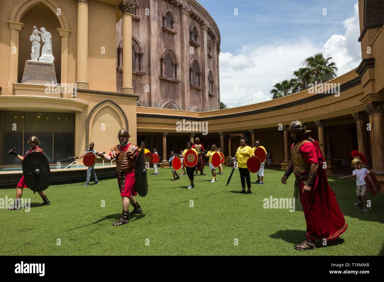 Orlando, Florida, USA. 3rd May, 2019. Visitors partake in a Roman soldier training camp at The Holy Land Experience (HLE) in Orlando, Florida. The theme park, owned by the Trinity Broadcasting Network, recreates the architecture and themes of the ancient city of Jerusalem in 1st-century Judea. HLE is a non-denominational Christian living biblical museum and church. The park opened in February 2001. There are multiple live performances given throughout various locations each the day in the park. Credit: Tracy Barbutes/ZUMA Wire/Alamy Live News Stock Photo