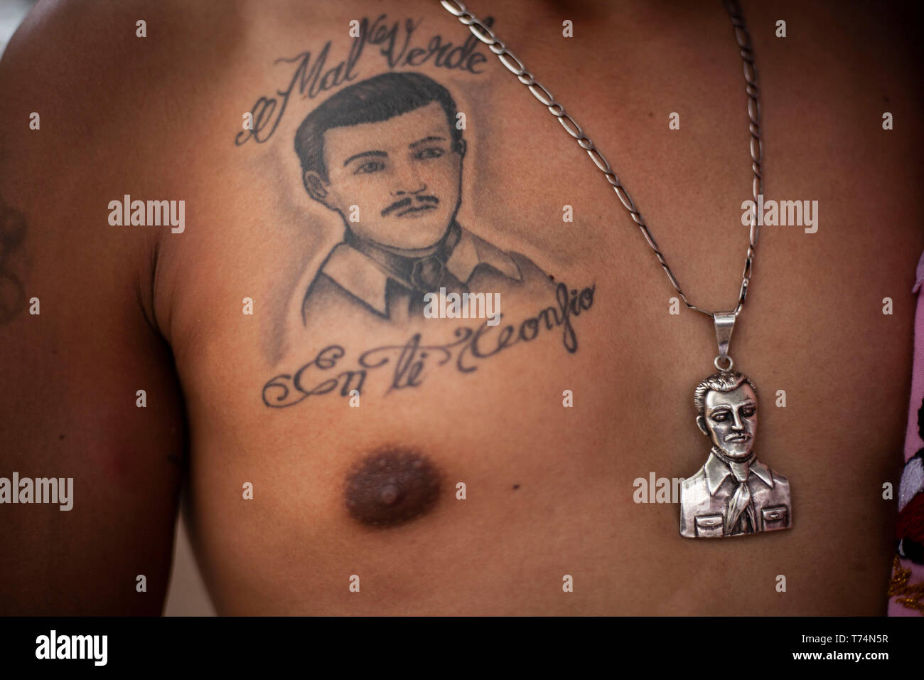 Culiacan, Mexico. 03rd May, 2019. A believer wears a medallion and has a tattoo of Jesus Malverde, who is considered a saint of drug bosses in Mexico. On the occasion of his 110th anniversary of death on 03.05.2019 numerous faithful gathered in his native town in the federal state of Sinaloa. Malverde, who is not recognized as a saint by the Catholic Church, is said to have been a highwayman during his lifetime. Many Mexicans worship him as a kind of Robin Hood. According to oral tradition, he robbed the rich families in the Sinaloa region and then distributed the booty among the poor. Credit: Stock Photo