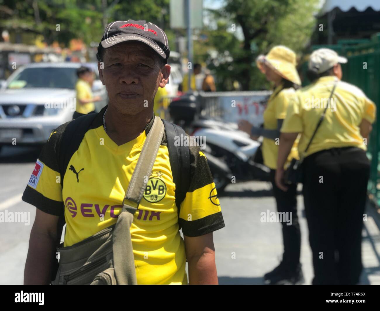 Bangkok, Thailand. 04th May, 2019. For the coronation of Thailand's King Maha Vajiralongkorn on Saturday in Bangkok, a supporter of the Bundesliga soccer team Borussia Dortmund has misappropriated his jersey. The military government had appealed to all Thais to wear yellow, the colors of the royal house. Maha Vajiralongkorn is the tenth king since the beginning of the Chakri Dynasty in 1782. He also bears the name Rama X. Credit: Christoph Sator/dpa/Alamy Live News Stock Photo