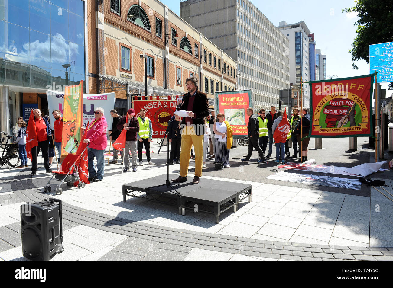 Cardiff, Wales, UK. 04th May, 2019.       Adam Johannes speaks to the rally on behalf of Kurdish hunger striker Imam Sis who has been on hunger strike for 140 days demanding that Turkey end the isolation of imprisoned Kurdish political leader Abdullah Ocalan during the annual Cardiff Trades Council May Day March and Rally in Cardiff, Wales on Saturday 4th May 2019. (Credit: Jeff Thomas | MI News) Credit: MI News & Sport /Alamy Live News Stock Photo