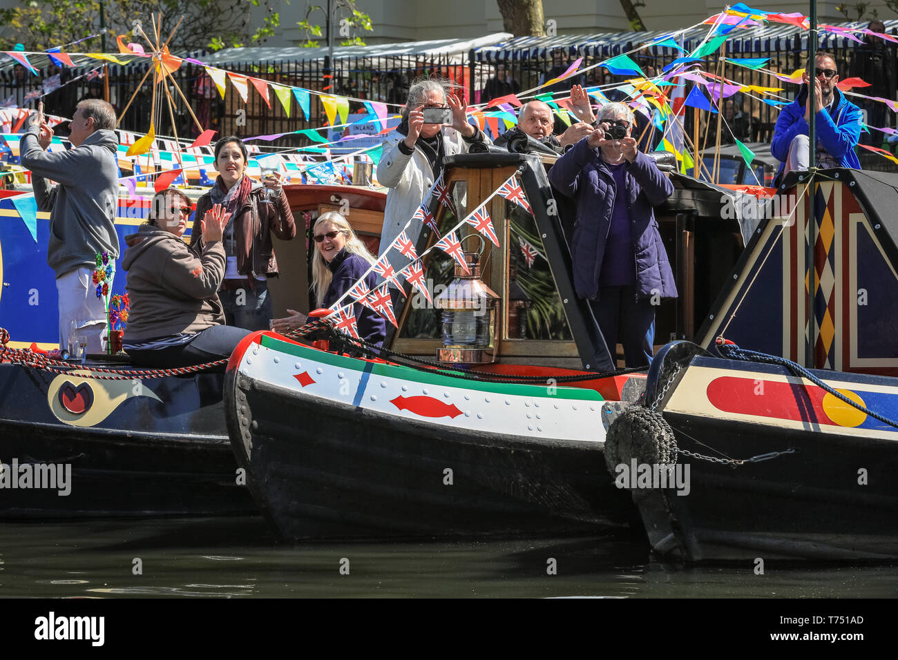London, UK. 4th May, 2019. Decorated narrowboats take part in the IWA Canalway Cavalcade Festival opening ceremony and pageant along the canalways and in the basin, as friendly owners all wave to participants and spectators. The popular festivities are organised by the Inland Waterways Association and will run 4-6th May and will feature more than 100 boats this year with canal boat pageants, an illuminated boat parade, music, stage performances and water sports along pool and Grand Union Canal in Little Venice.Little Venice, London, UK, 4th May 2019. Credit: Imageplotter/Alamy Live News Stock Photo