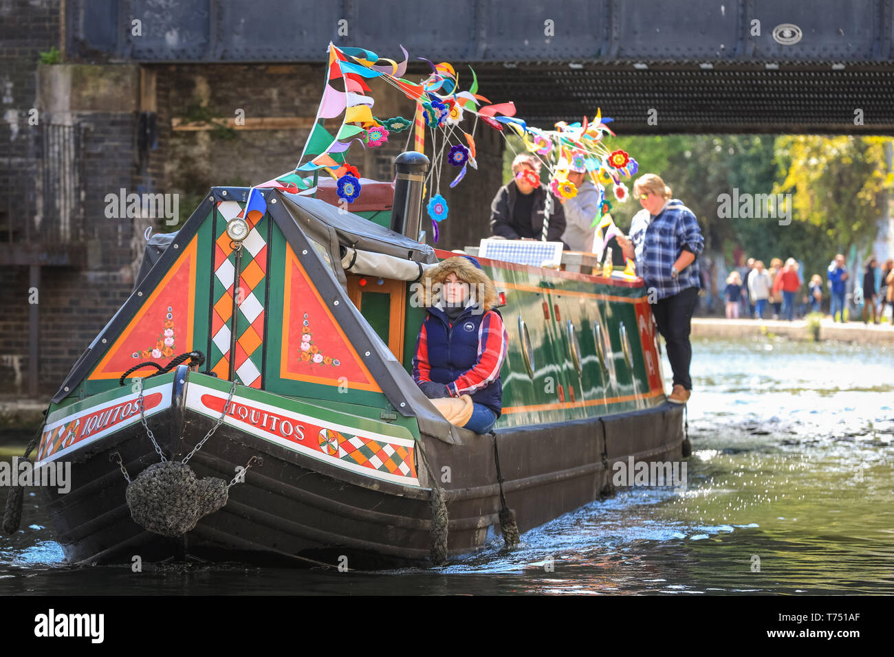 London, UK. 4th May, 2019. The 'Iquitos' passes under a bridge. The popular festivities are organised by the Inland Waterways Association and will run 4-6th May and will feature more than 100 boats this year with canal boat pageants, an illuminated boat parade, music, stage performances and water sports along pool and Grand Union Canal in Little Venice.Little Venice, London, UK, 4th May 2019. Mark Saxon, IWA Canalway Cavalcade Chairman, shows of this year's red canal boat hat. Credit: Imageplotter/Alamy Live News Stock Photo