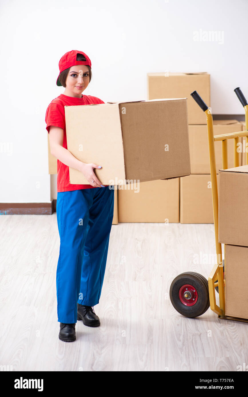 Young female professional mover doing home relocation Stock Photo