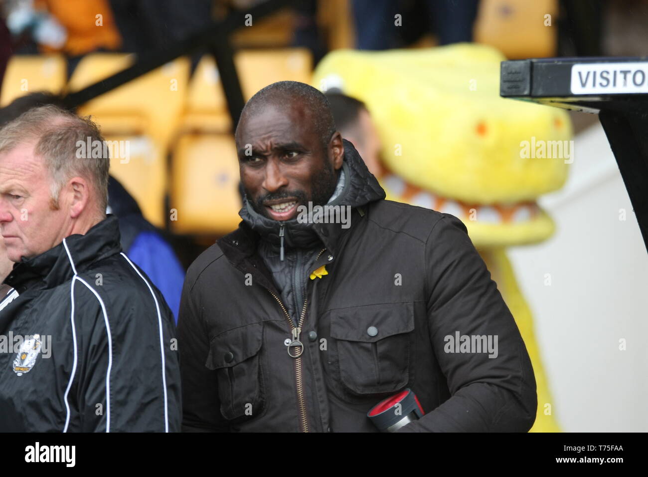 Burslem, Stoke-On-Trent. 27th April, 2019. Macclesfield Town manager Sol Campbell in the dugout at Port Vale's Vale Park. Stock Photo