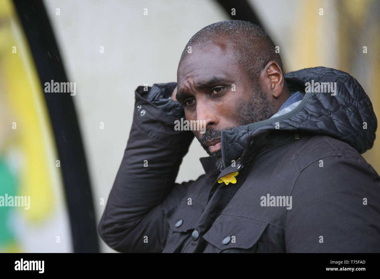 Burslem, Stoke-On-Trent. 27th April, 2019. Macclesfield Town manager Sol Campbell in the dugout at Port Vale's Vale Park. Stock Photo