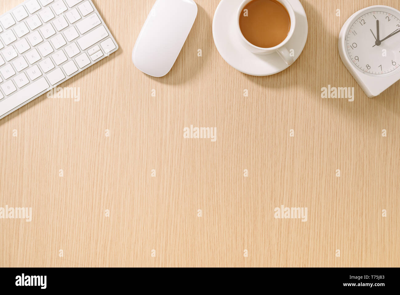 Modern white office desk with keyboard, mouse, oclock and cup of coffee.Top view with copy paste. Business and strategy concept mockup. Stock Photo