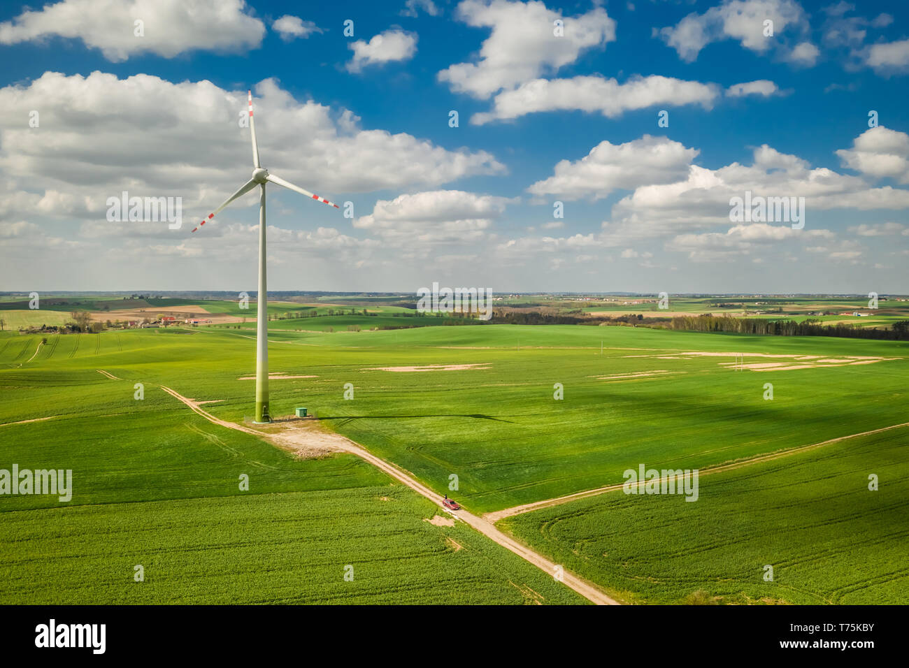 Wind turbines on field and blue sky with clouds Stock Photo - Alamy