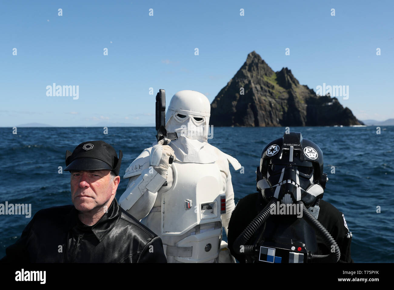 Members of the '501st Legion Ireland Garrison' dressed as a 'Snow Trooper' (centre), 'Tie Fighter' (right) and '1st Order General' George Bracebridge on a boat trip to Skellig Michael, where scenes from Star Wars were filmed, during the May the 4th Festival in Portmagee. Stock Photo