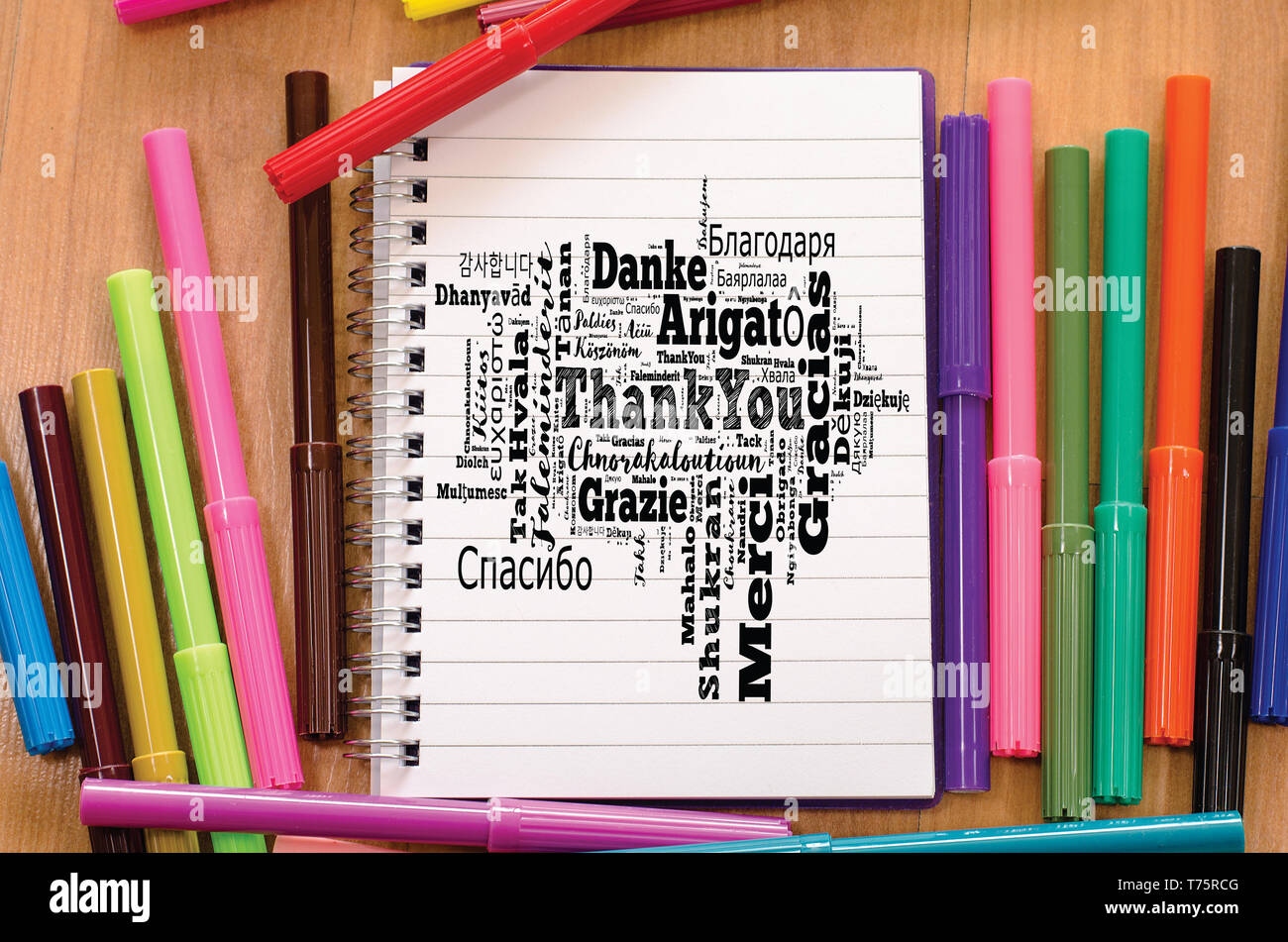 Thank You word cloud in different languages over notepad background Stock Photo