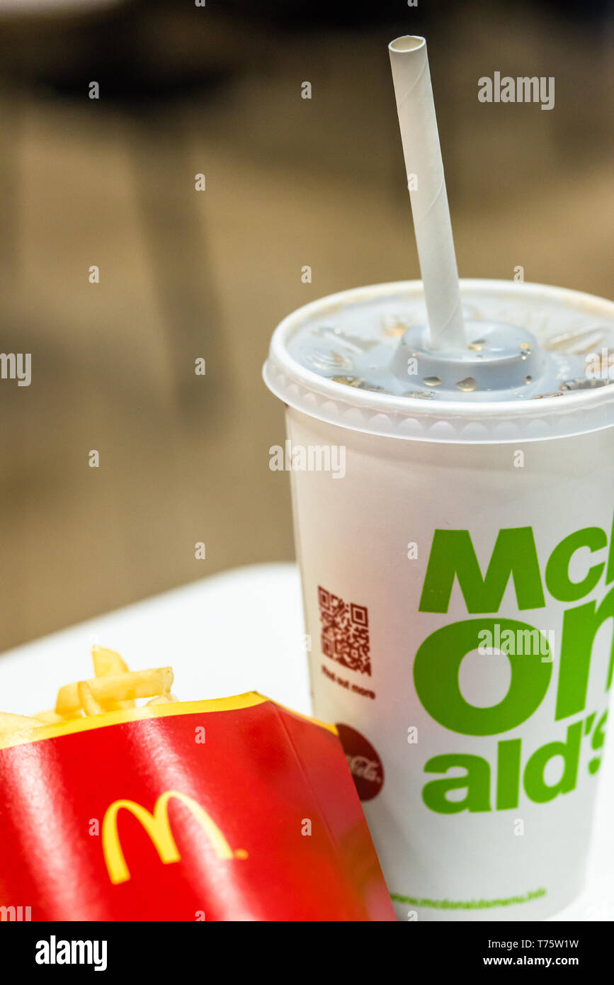Mcdonalds paper straws recently replaced plastic at their UK stores to combat plastic polution following a petition by sumofus. Stock Photo