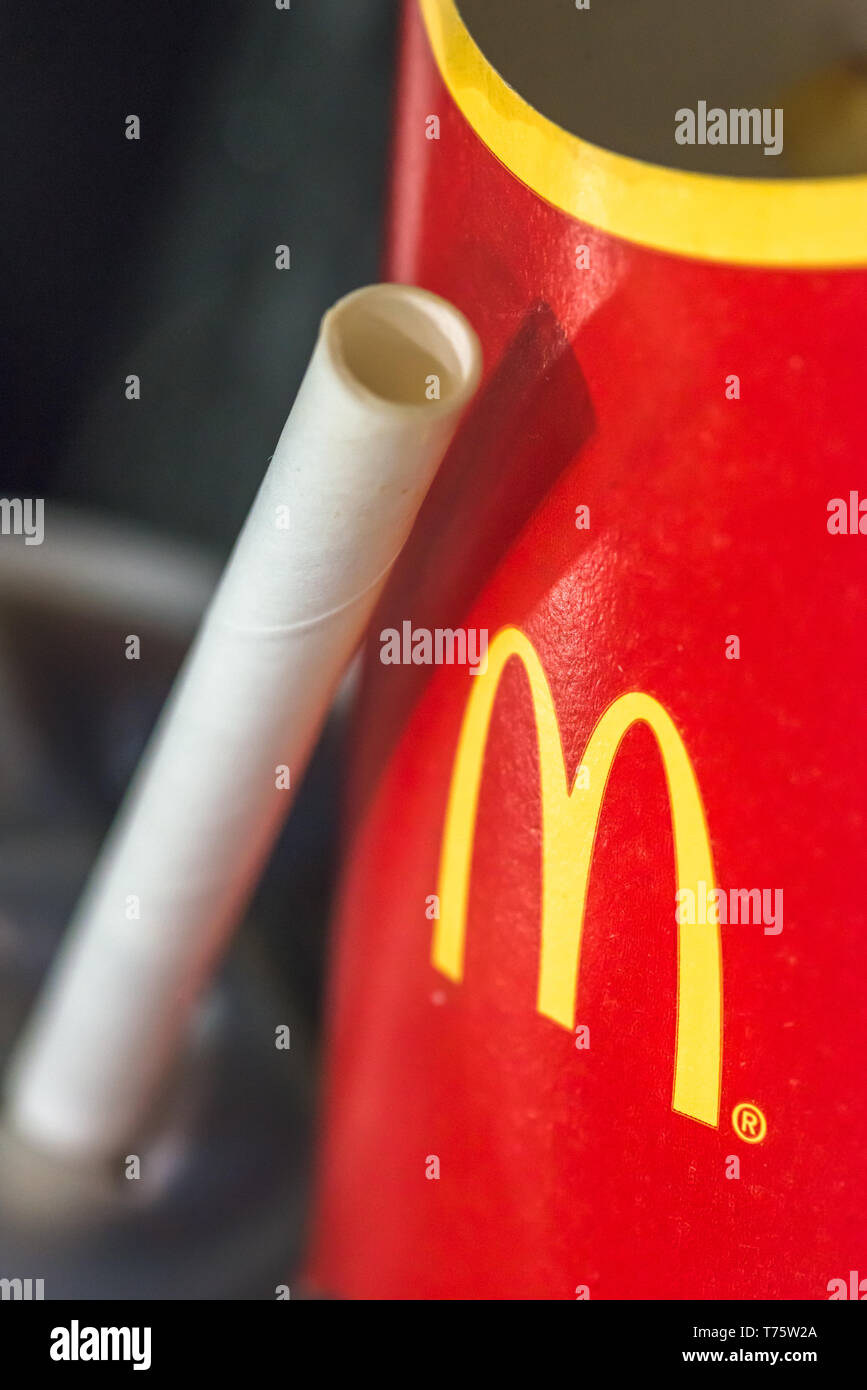 Mcdonalds paper straws recently replaced plastic at their UK stores to combat plastic polution following a petition by sumofus. Stock Photo