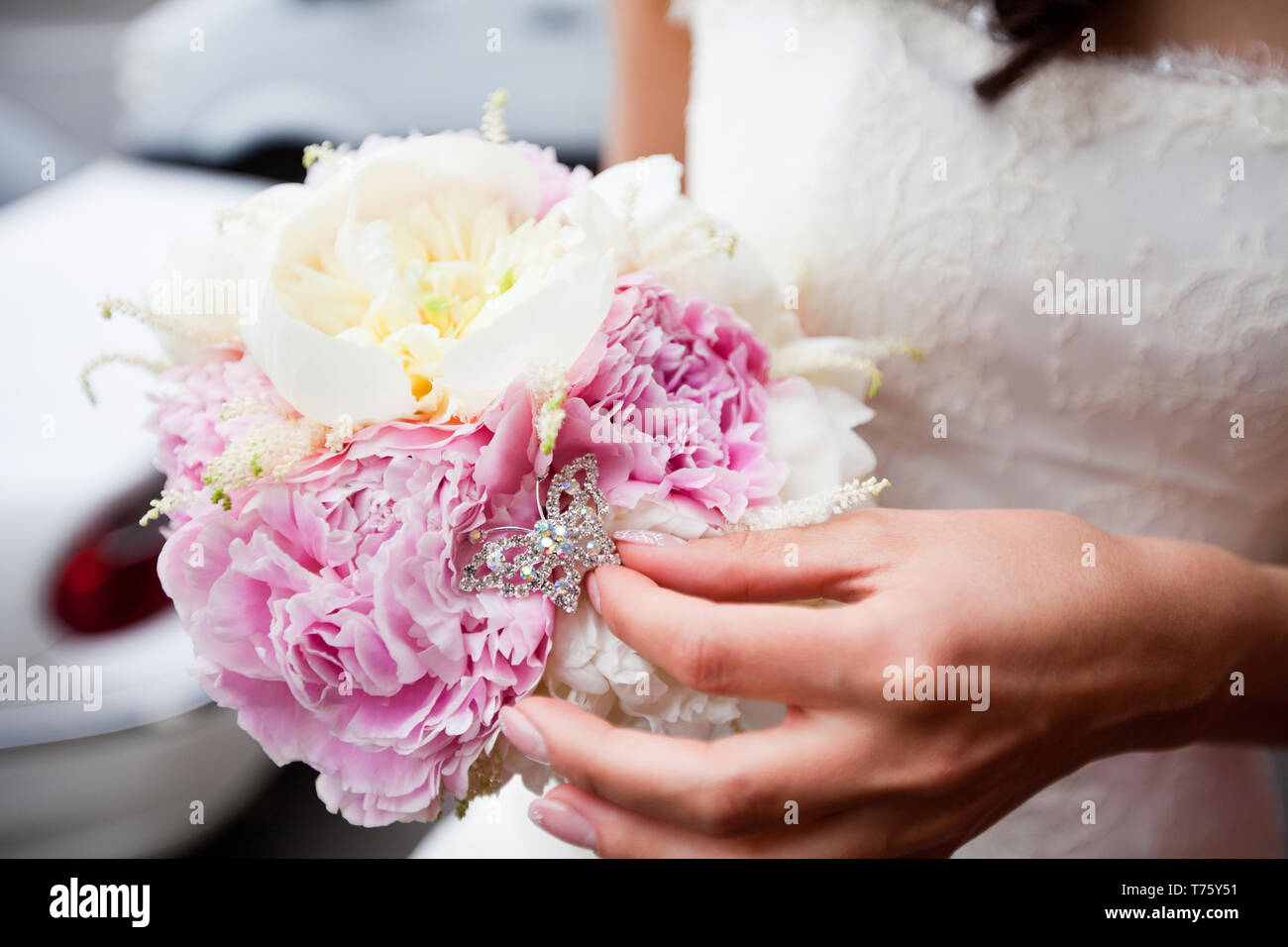 Refined bouquet of white and pink peonies in the hands of an ...