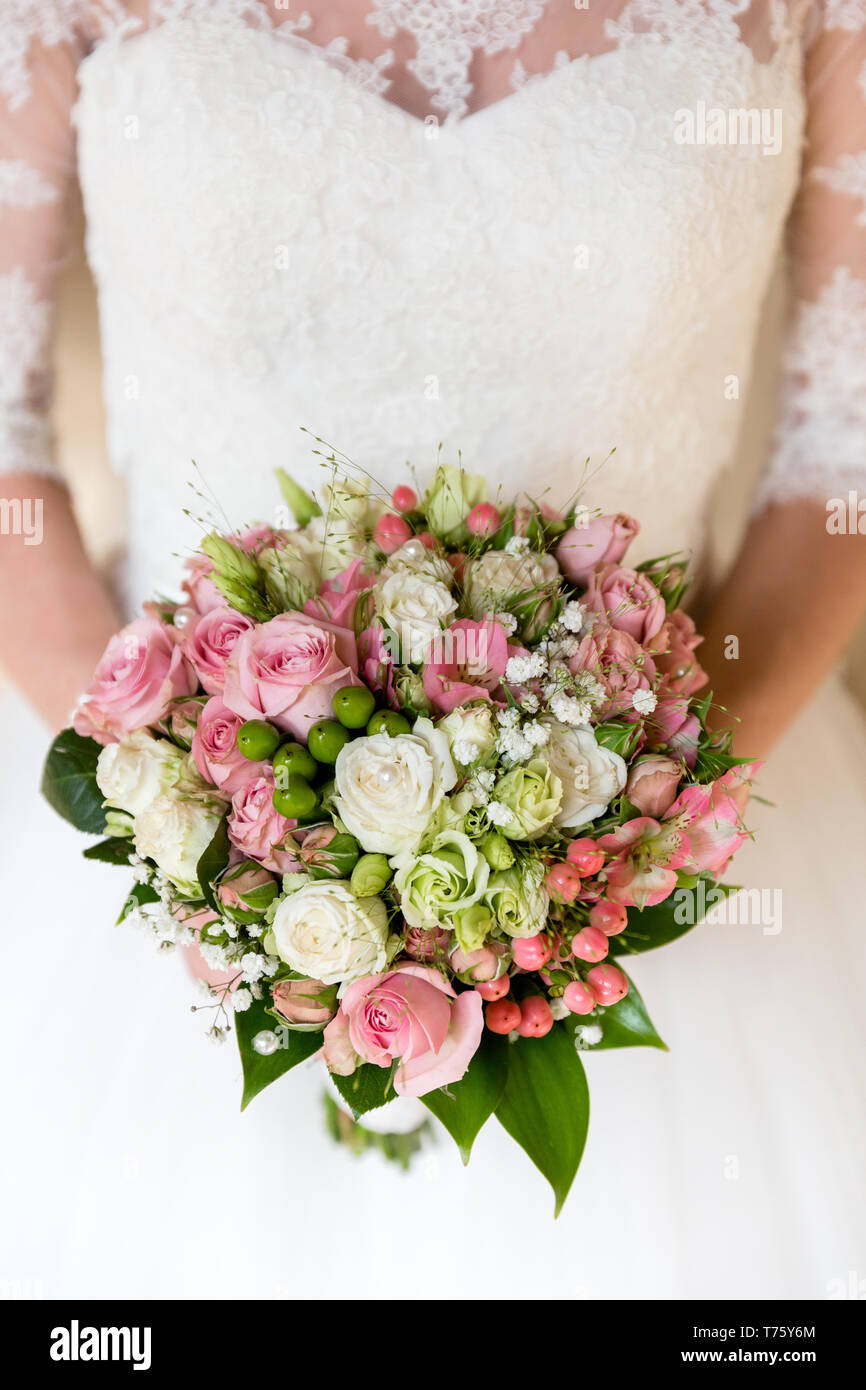 Romantic bouquet of pink and white roses in the hands of an ...