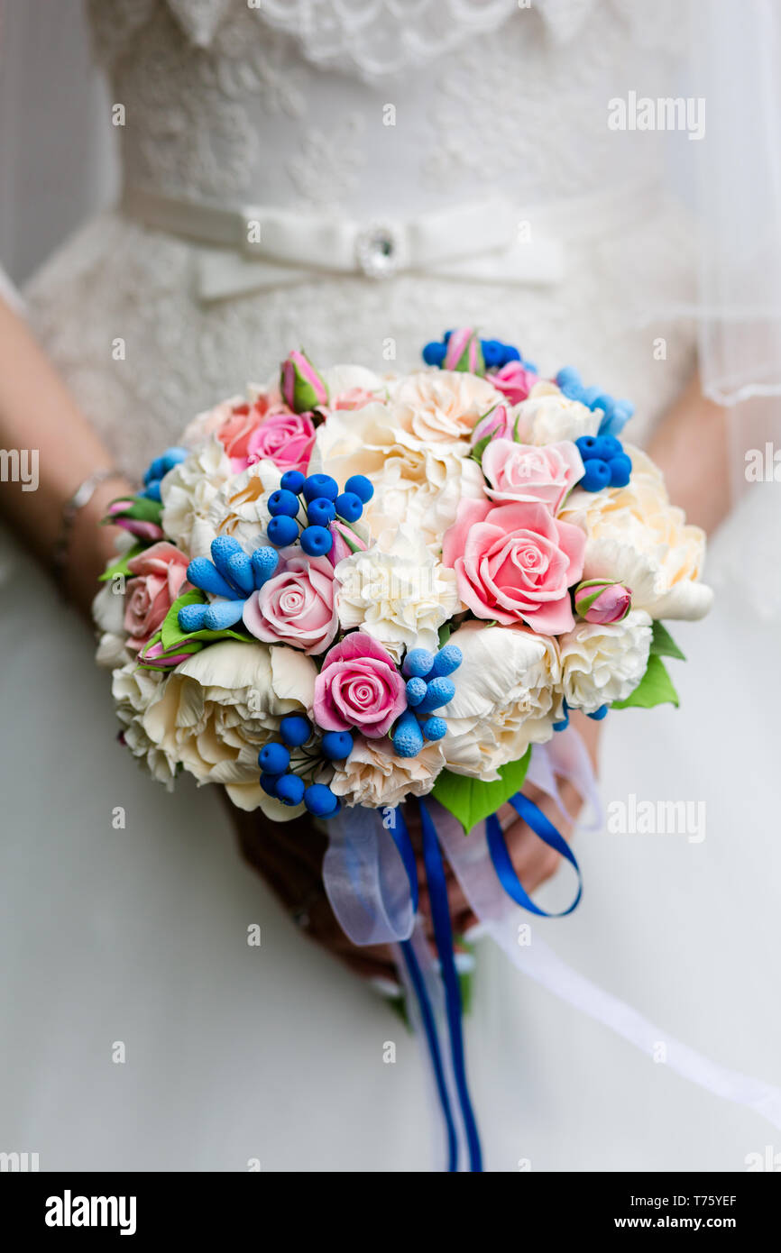 Beautiful bridal bouquet of peonies and pink roses in the hands of an ...