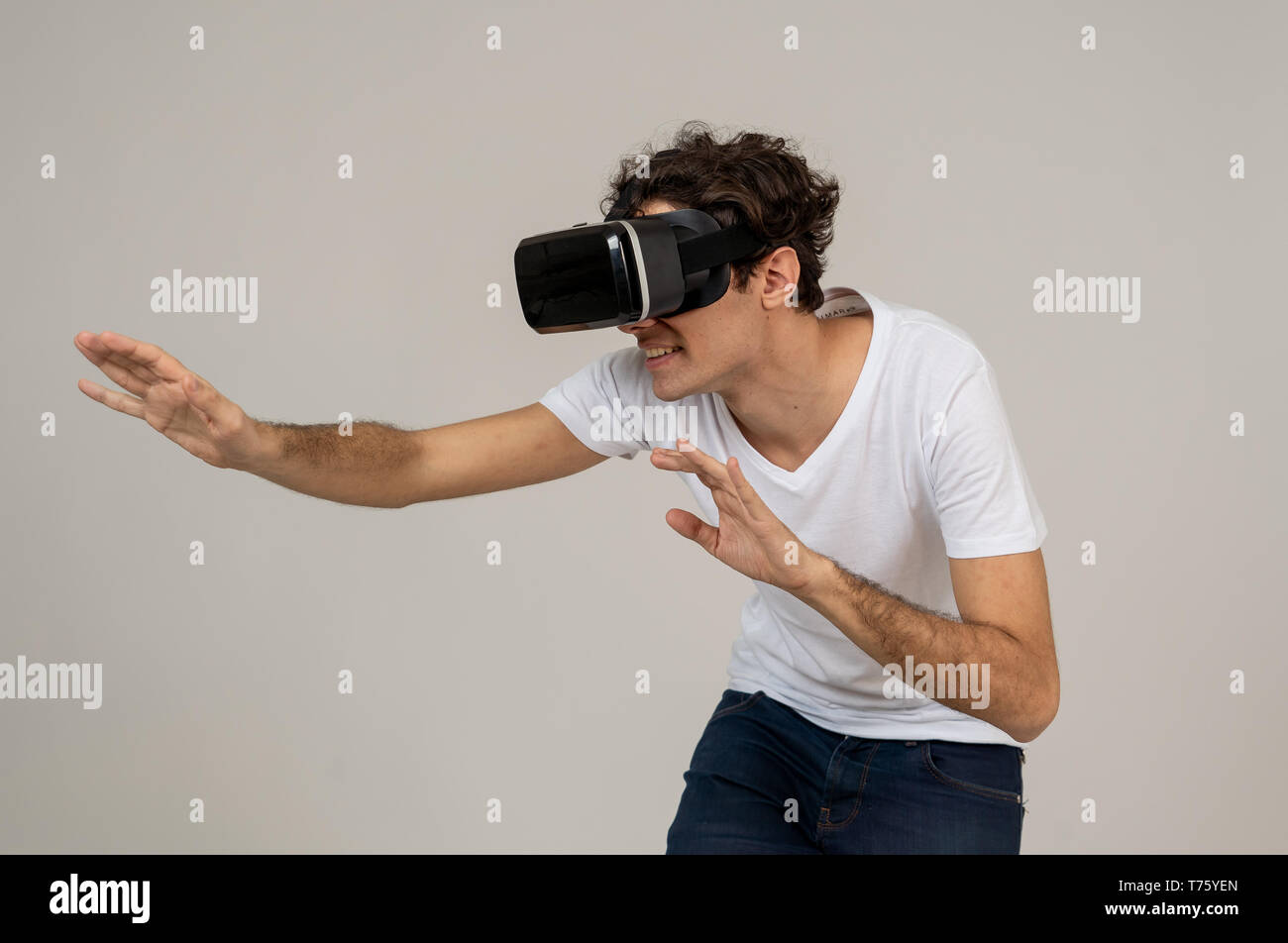 Amazed funny man using VR headset glasses touching and interacting with