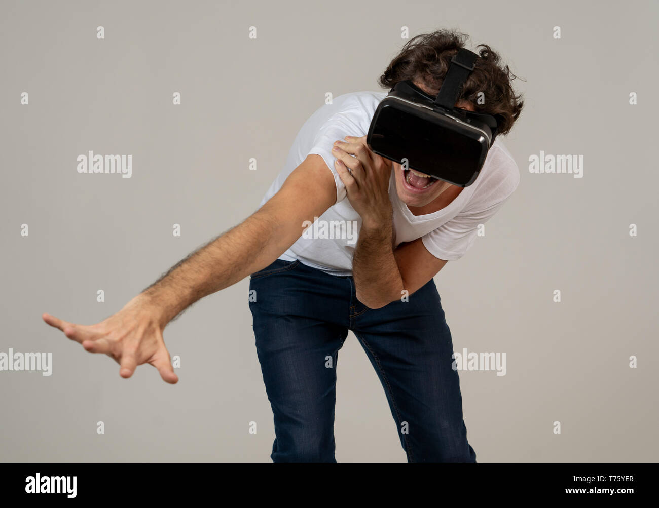 Amazed funny man using VR headset glasses touching and interacting with