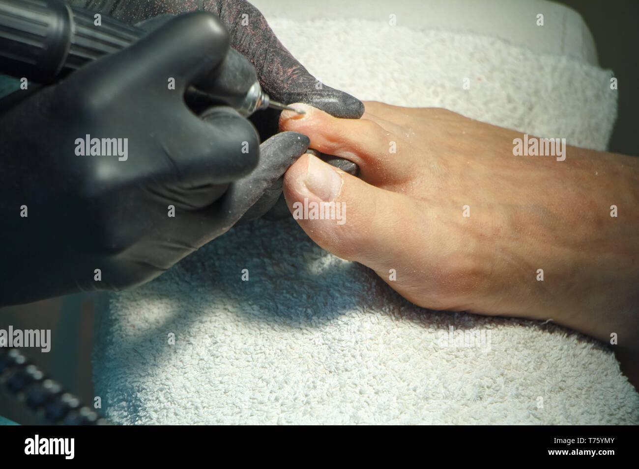 Professional hardware pedicure using electric machine.Patient on