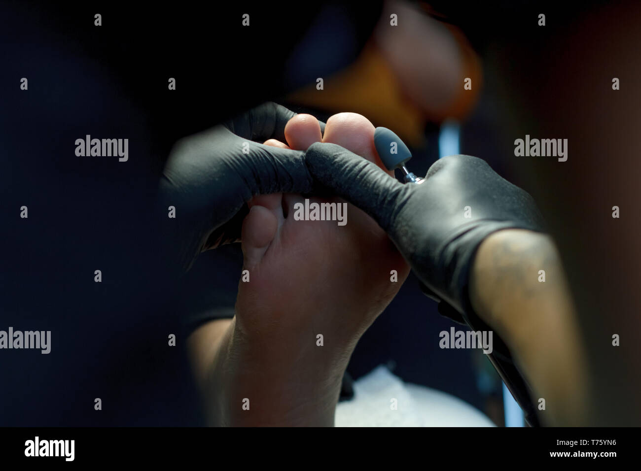 Professional hardware pedicure using electric machine.Patient on