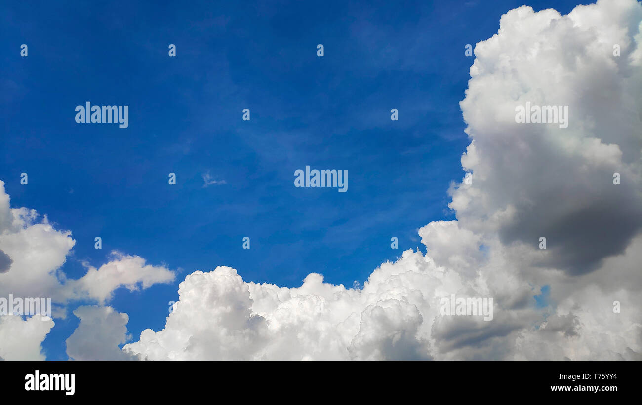 Beautiful blue sky and large white cumulus clouds, soft focus, background or concept. Stock Photo
