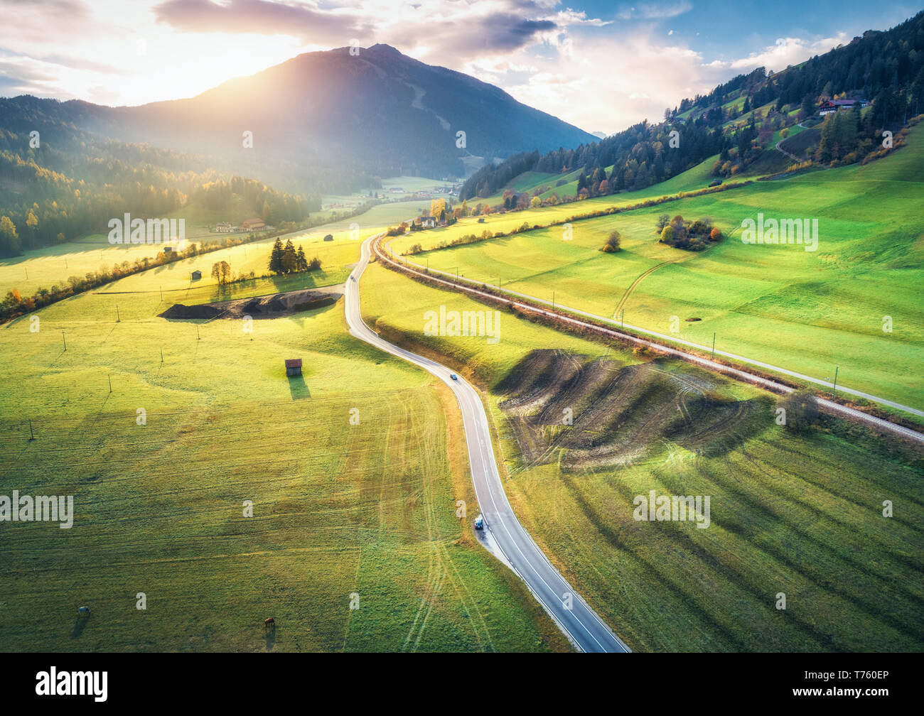 Aerial view of the road in mountain valley at sunset in summer in ...