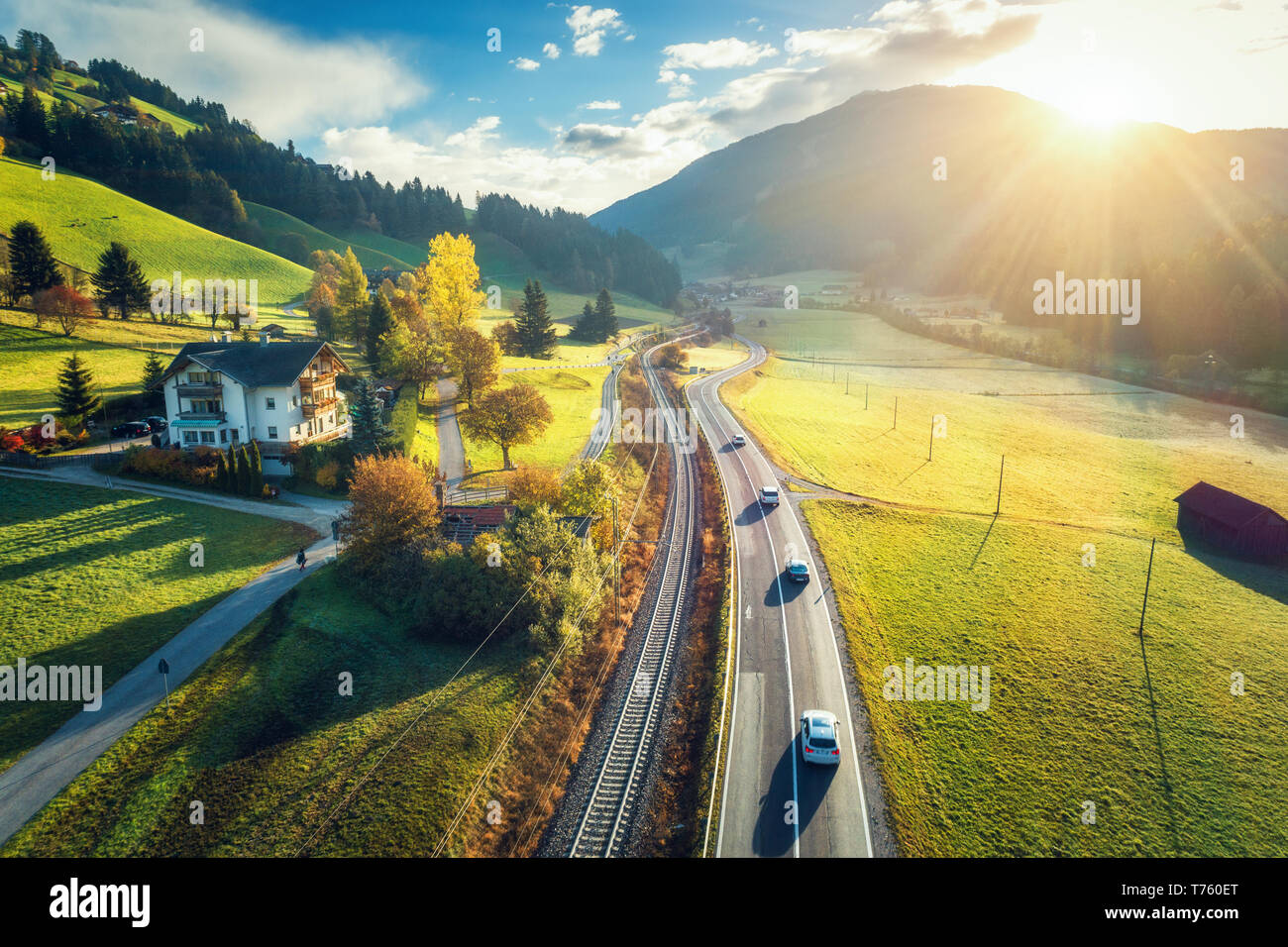 Aerial view of the road in mountain valley at sunset in spring in ...