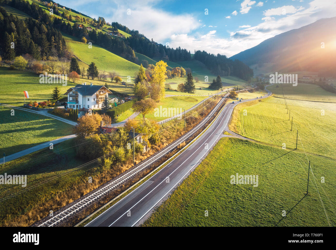 Aerial view of the road in mountain valley at sunset in summer in ...