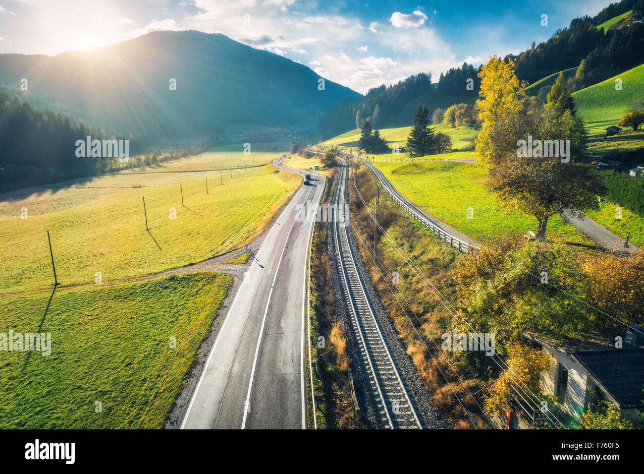 Aerial view of the road in mountain valley at sunset in spring in ...