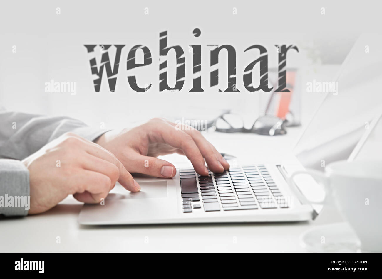 Webinar online, internet education, e-learning concept. Man typing on laptop keyboard. Stock Photo