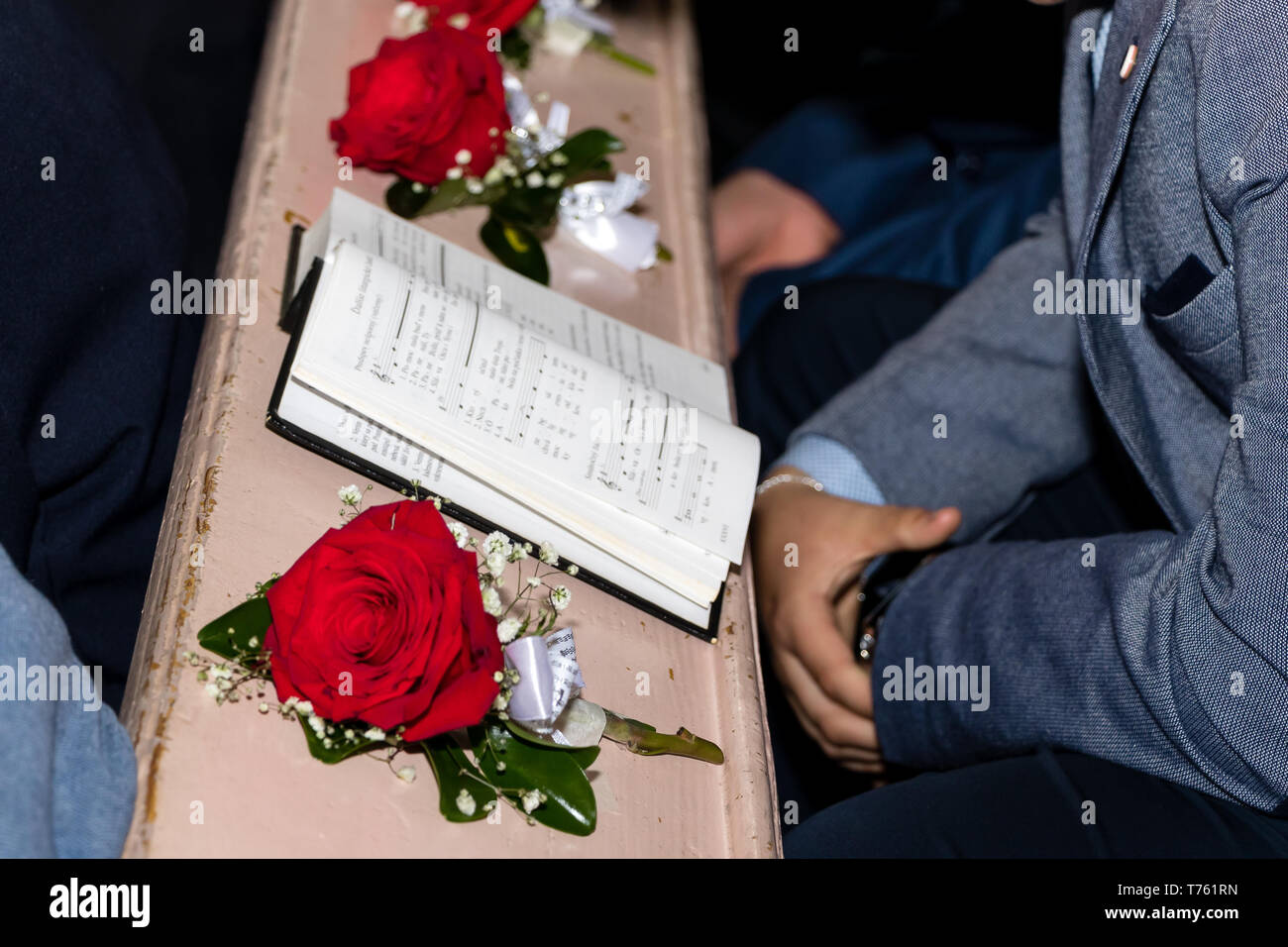 Novi Sad, Serbia - April 28, 2019: The anglican hymn book and red roses in church Stock Photo