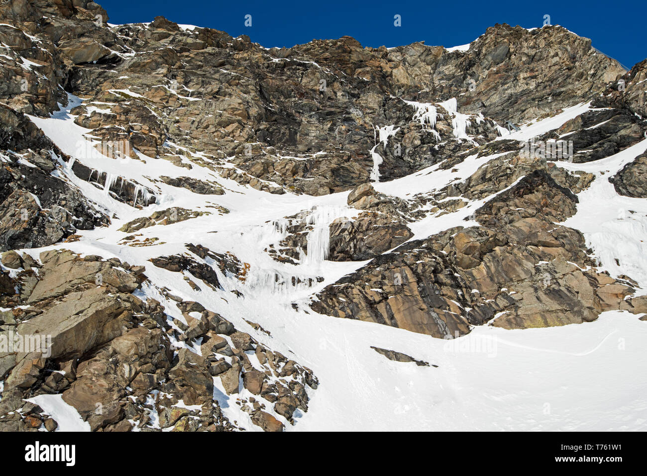 Rugged Alpine Rocky Mountainside With Frozen Waterfall Covered In Snow And Ice Stock Photo Alamy Rugged Alpine Rocky Mountainside With Frozen Waterfall Covered In Snow And Ice Stock Photo Alamy