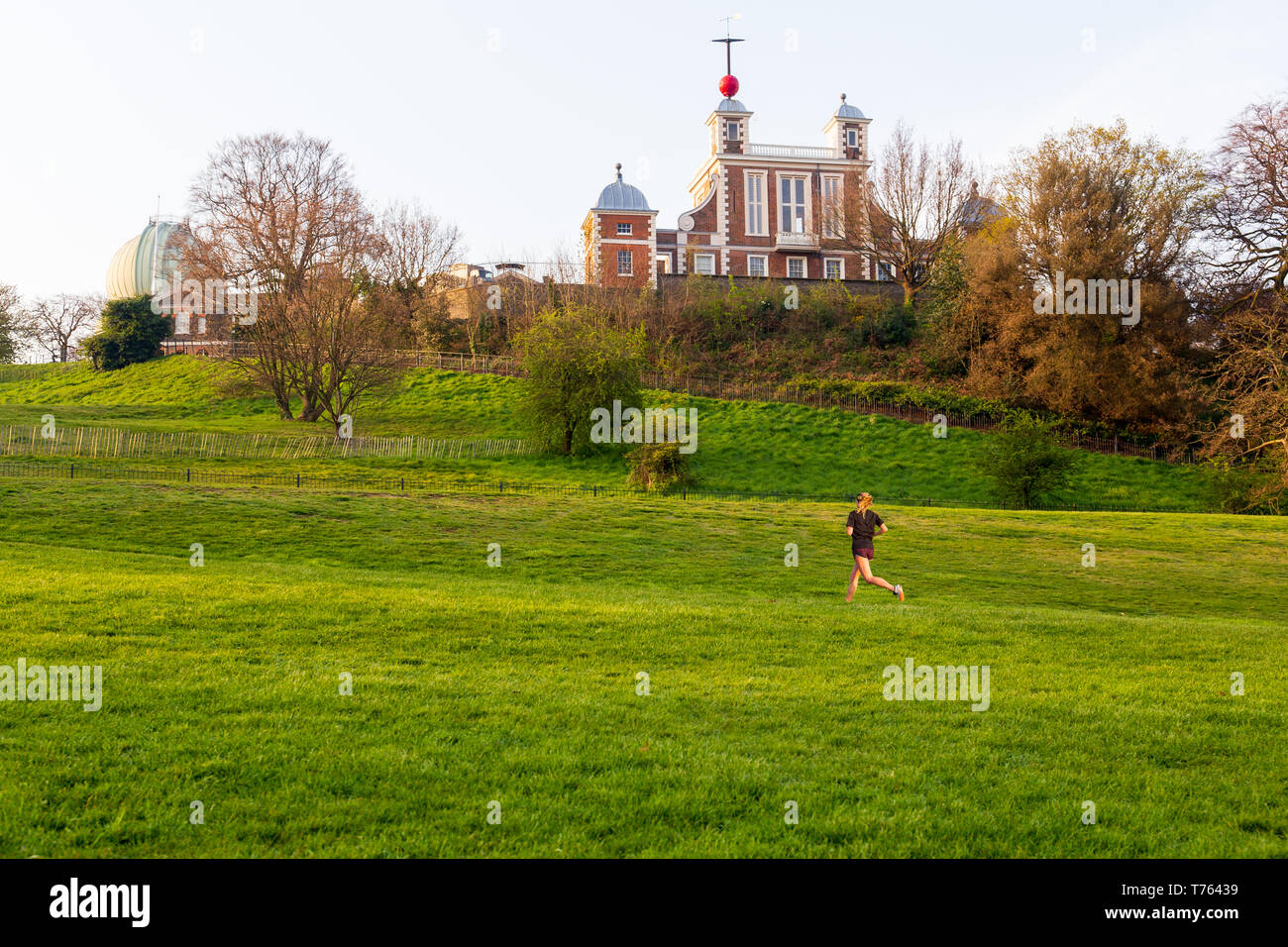 London Greenwich park with woman jogging exercise in summer. Stock Photo