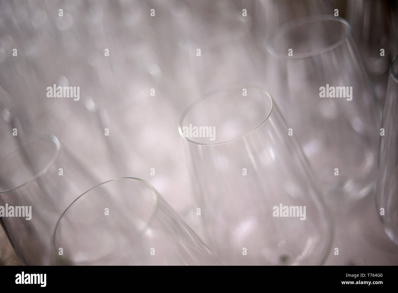 Close up of lots of empty wine glasses displayed on a table Stock Photo