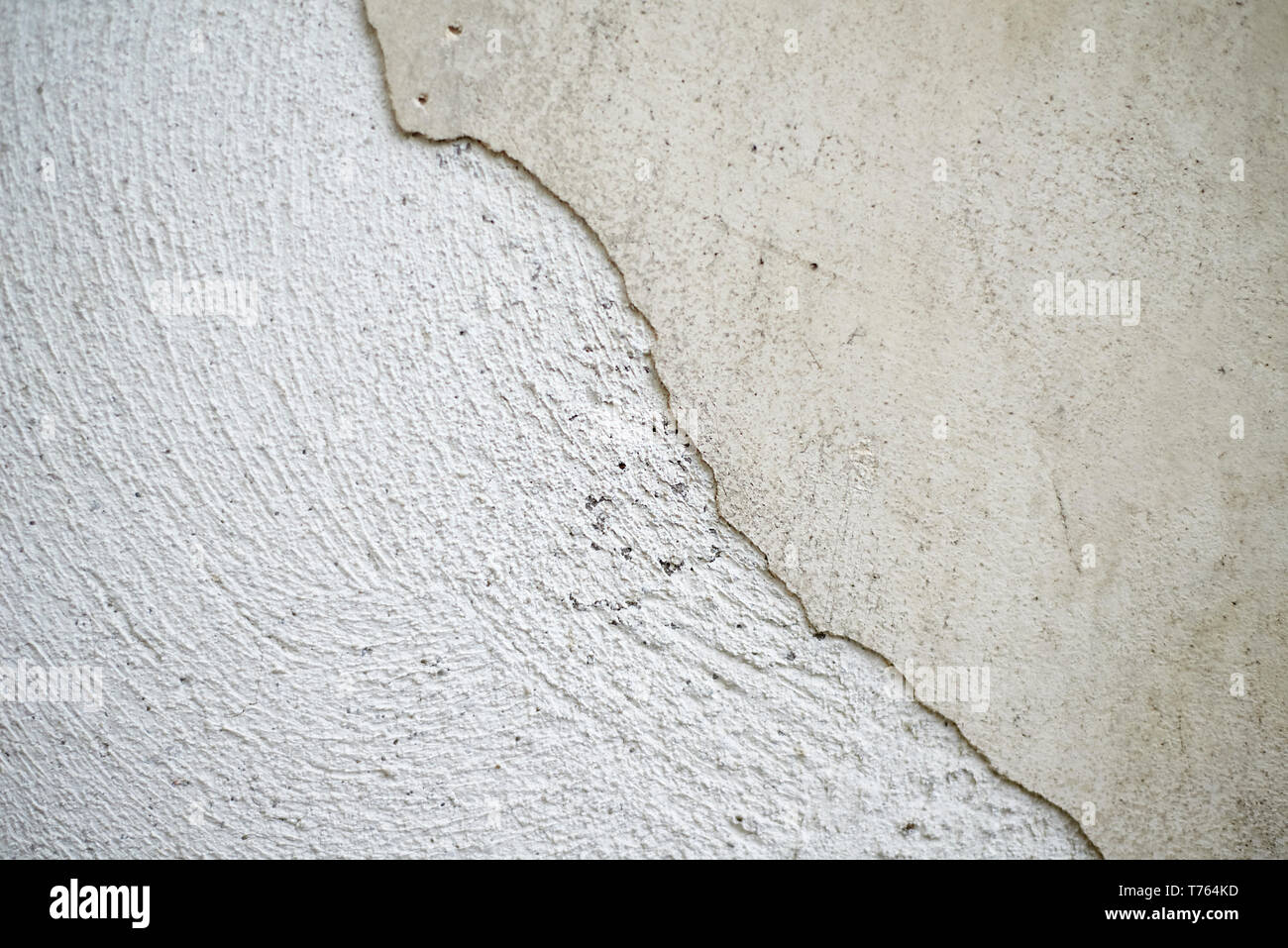 Close up of an old crumbling wall with the paint coming off of it and