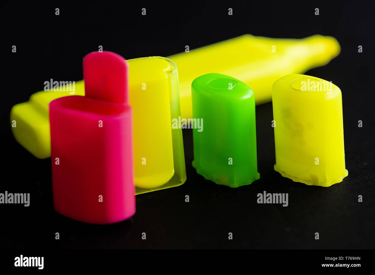 colored highlighter caps caps on black background Stock Photo Alamy