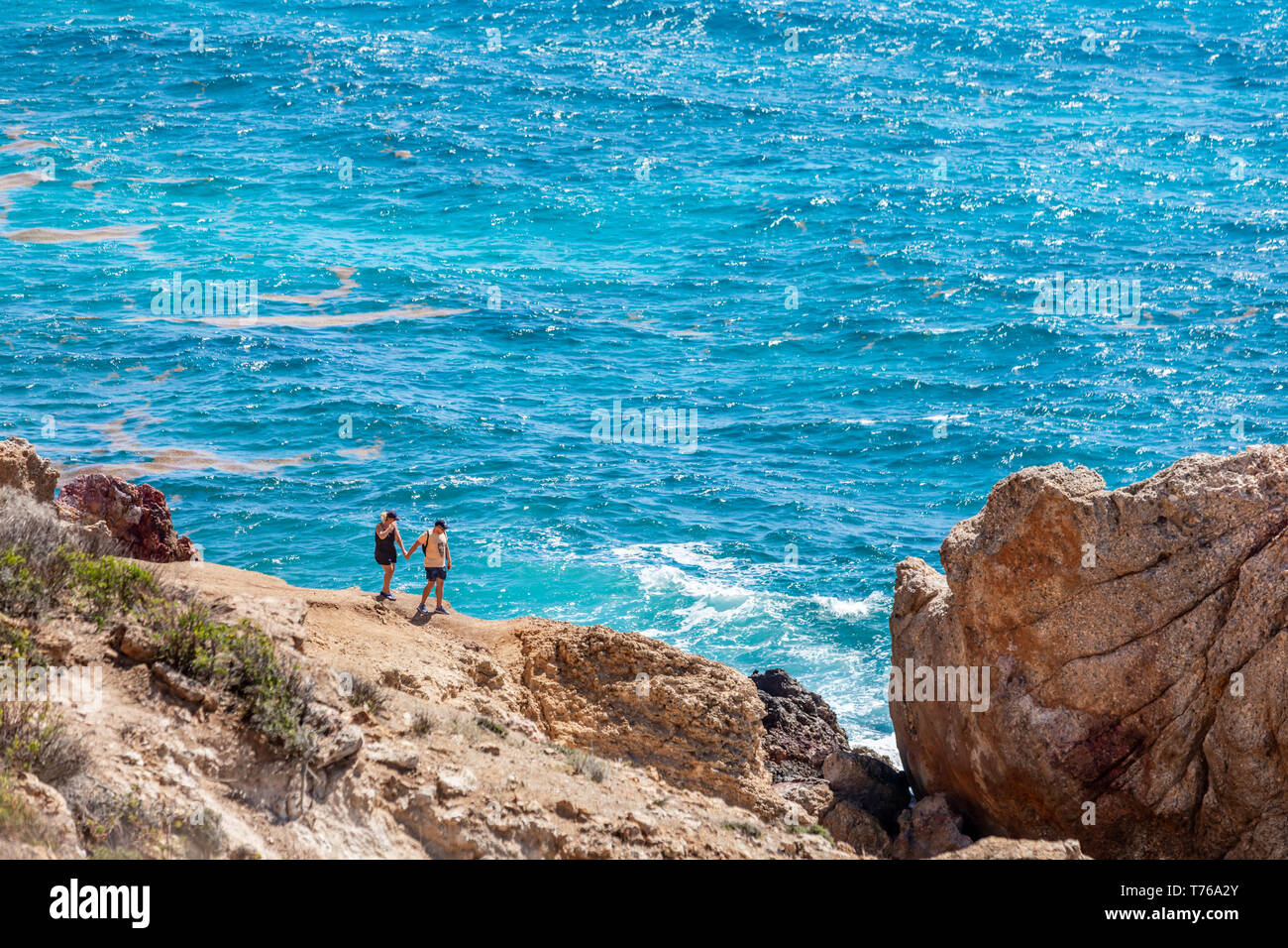 couple hiking at the tidal pools at Grand Fond in St Barts Stock Photo