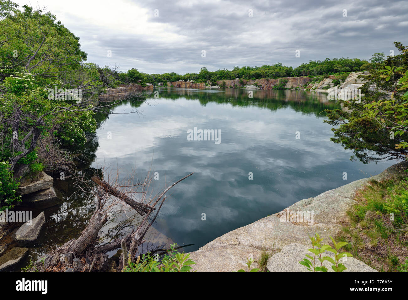 Old granite quarry pit at Halibut Point State Park in Rockport, Massachusetts Stock Photo