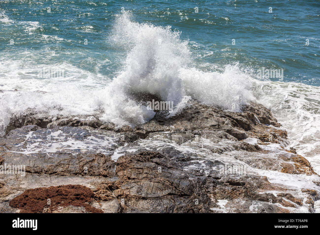 Ocean waves crashing on a rocky shore at Grand Fond in St Barts Stock Photo