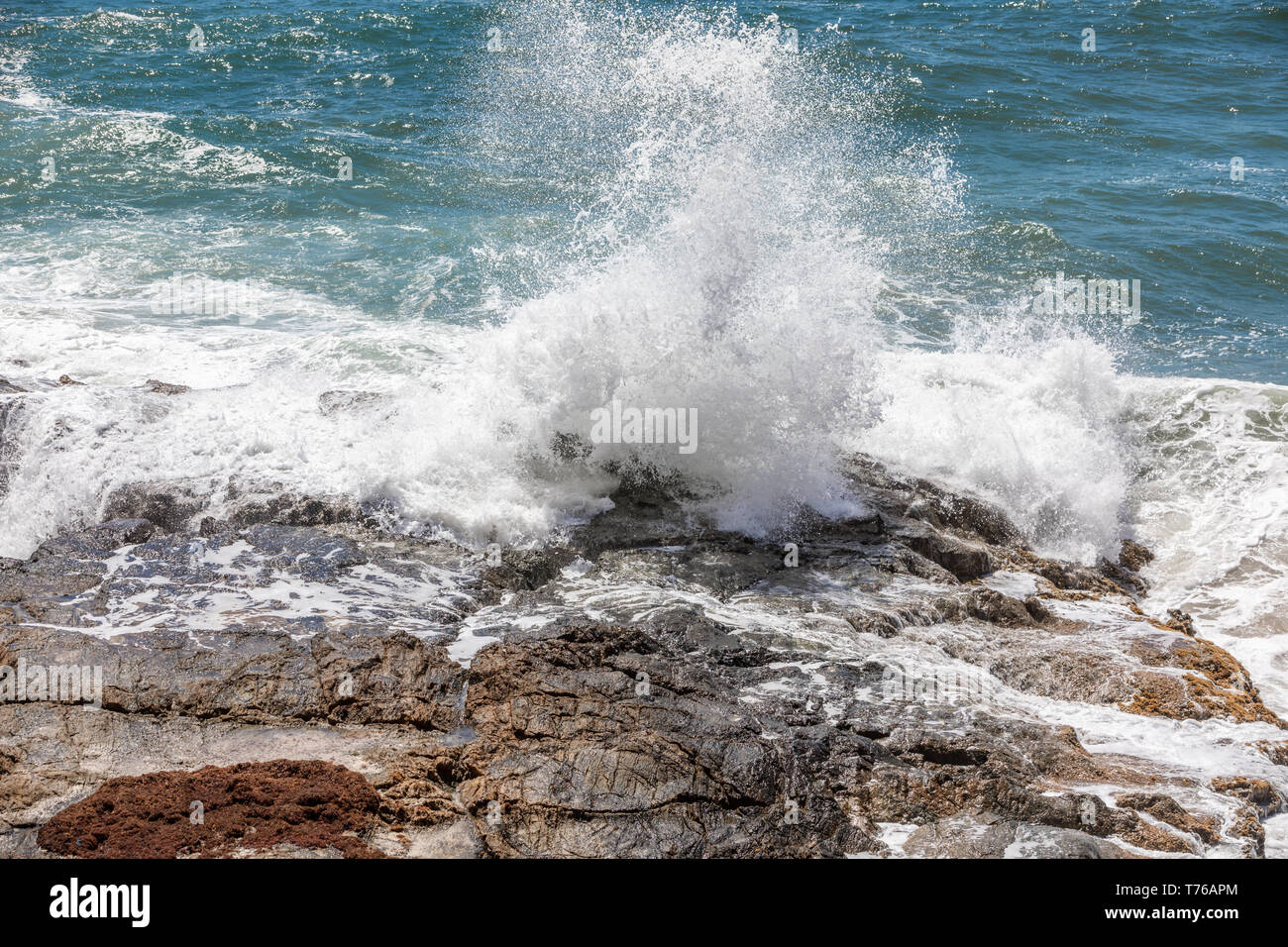 Ocean waves crashing on a rocky shore at Grand Fond in St Barts Stock Photo