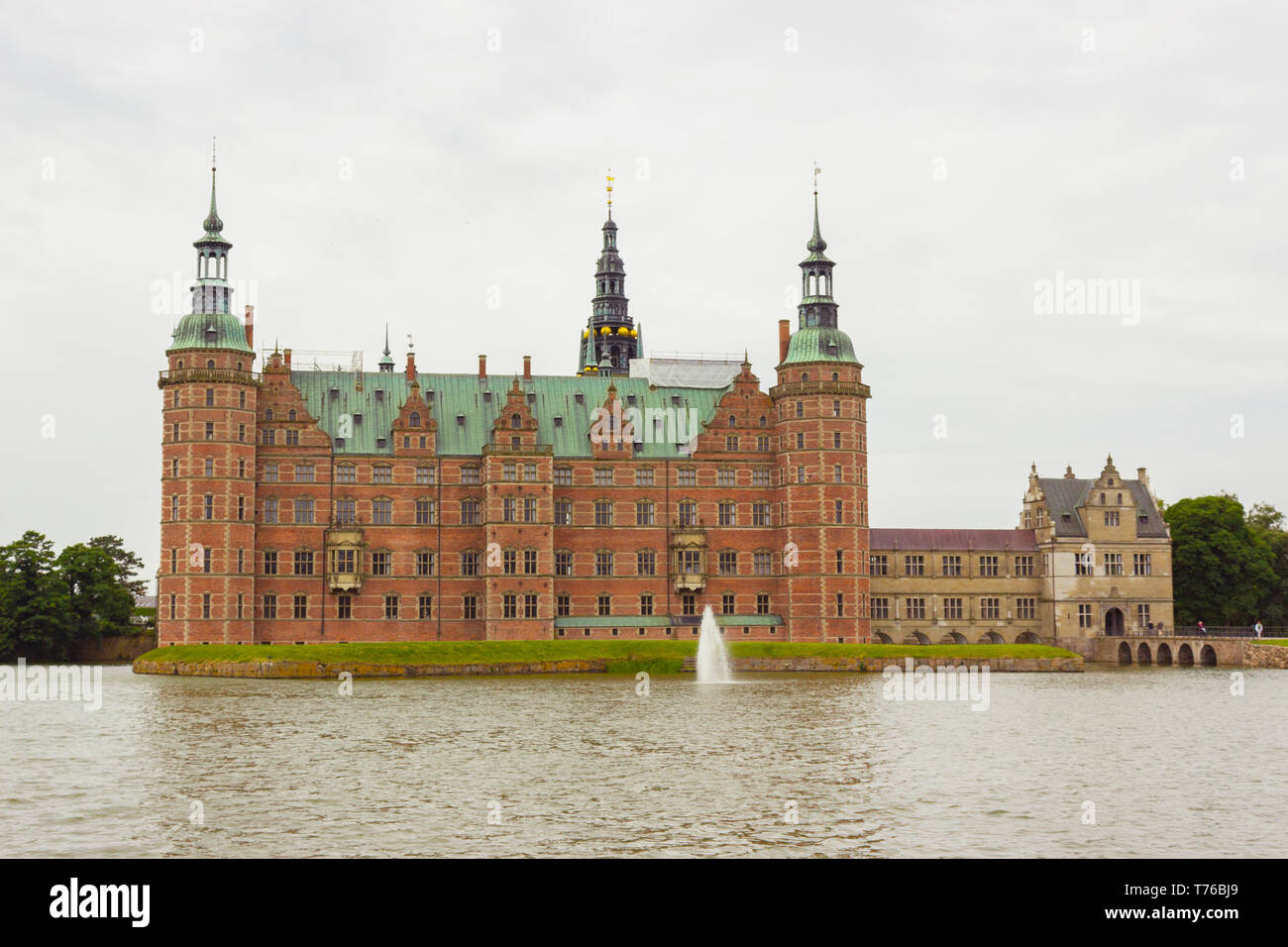 Beautiful view of Fredensborg palace in Hilleroed, Denmark. Was shot from public park. Frederiksborg palace and fountain in the palace lake, Hillerod, Stock Photo