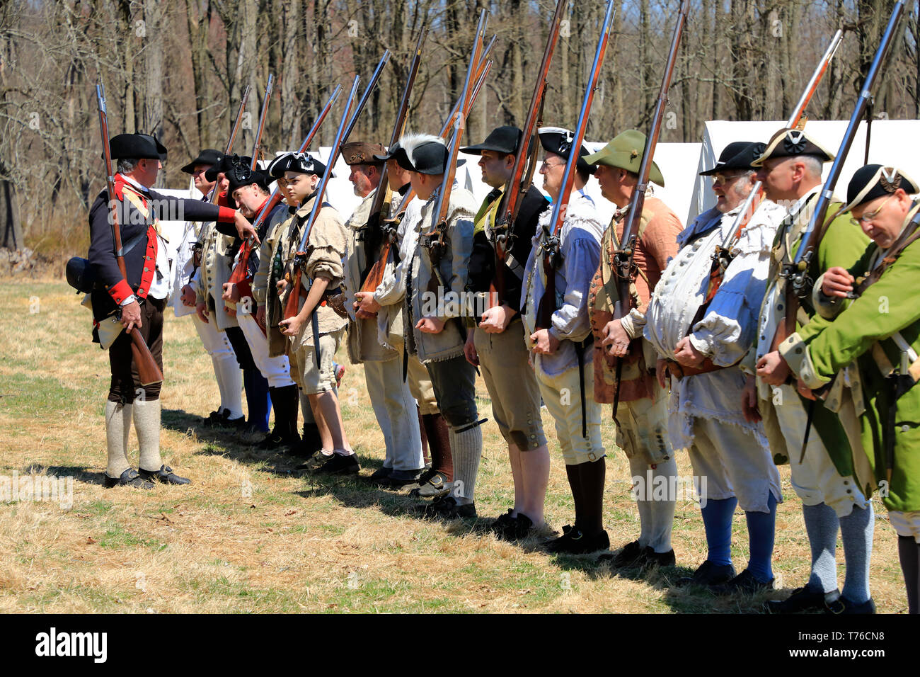 Reenactors of American Continental Army soldiers and an officer in Jockey Hollow Historical Park during annual Jockey Hollow Encampment.New Jersey.USA Stock Photo