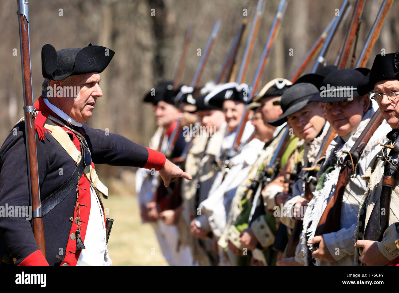 Reenactors of American Continental Army soldiers and an officer in Jockey Hollow Historical Park during annual Jockey Hollow Encampment.New Jersey.USA Stock Photo