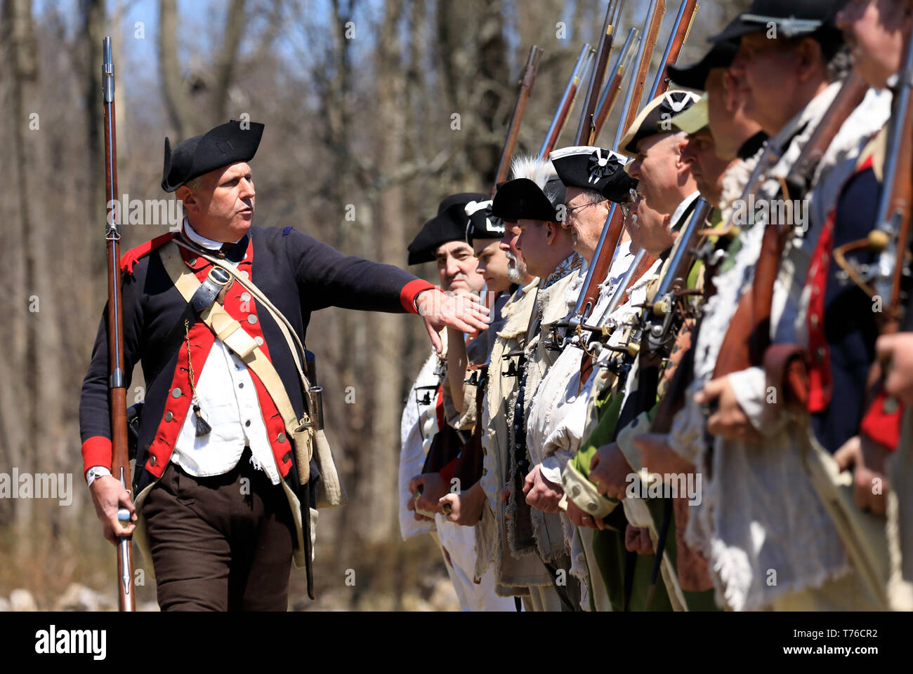 Reenactors of American Continental Army soldiers and an officer in Jockey Hollow Historical Park during annual Jockey Hollow Encampment.New Jersey.USA Stock Photo