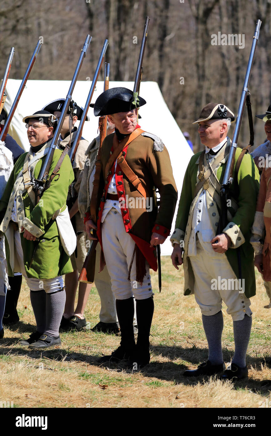 Reenactors of American Continental Army soldiers and an officer in Jockey Hollow Historical Park during annual Jockey Hollow Encampment.New Jersey.USA Stock Photo