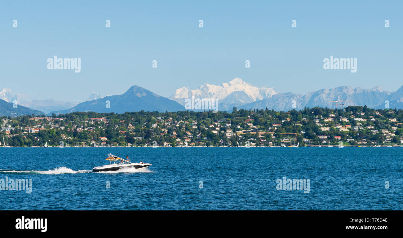 27th Aug 2018. Geneva, Switzerland. Luxury jet boat on a Lake Geneva. Snowy mountain of Mont Blanc in the background. Stock Photo