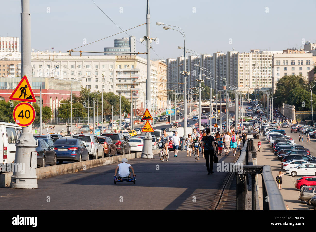 Krymsky Val (Garden Ring) with unidentified people heading for the Gorky Park and large apartment buildings on the background. Moscow, Russia. Stock Photo