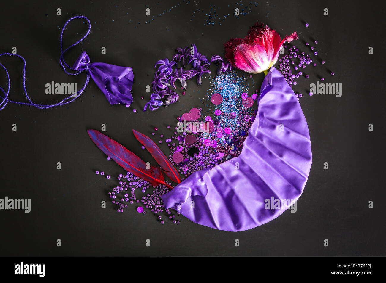 Composition with different items in purple colors on dark background Stock Photo