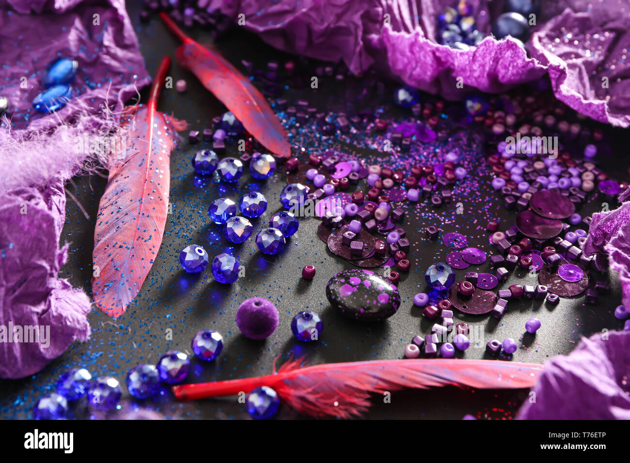 Composition with different items in purple colors on dark background Stock Photo
