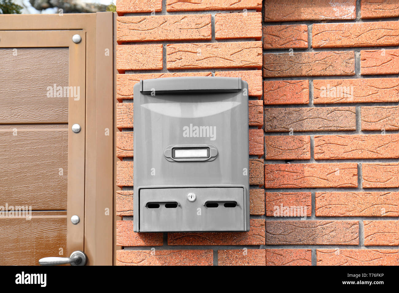 Modern mailbox on fence outdoors Stock Photo - Alamy