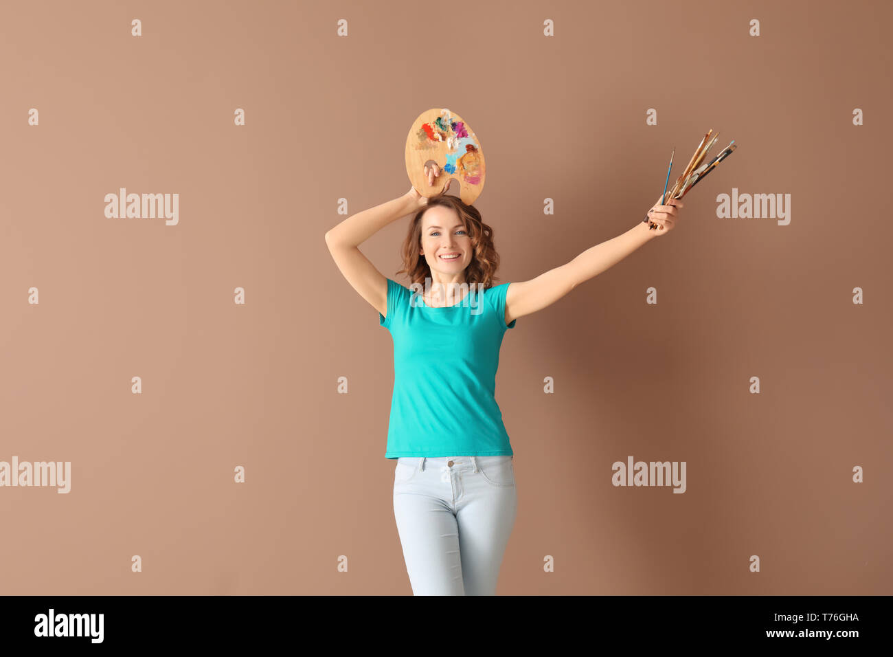 Female artist with tools and paint palette on color background Stock ...